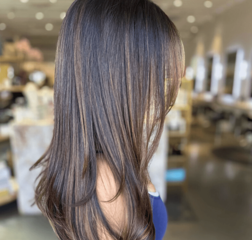 Natural-looking hair extensions for thinning hair with seamless brunette blend and added density.